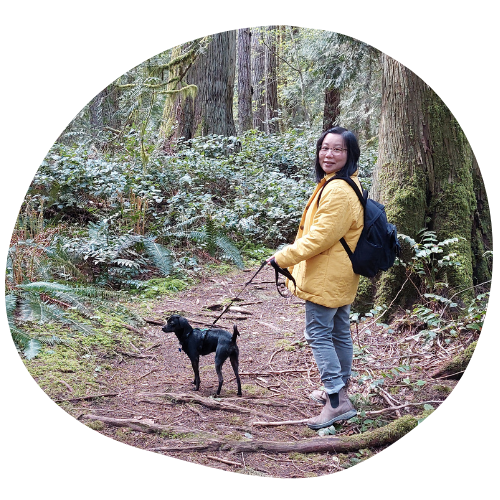 Crystal Lee and dog on a forest path